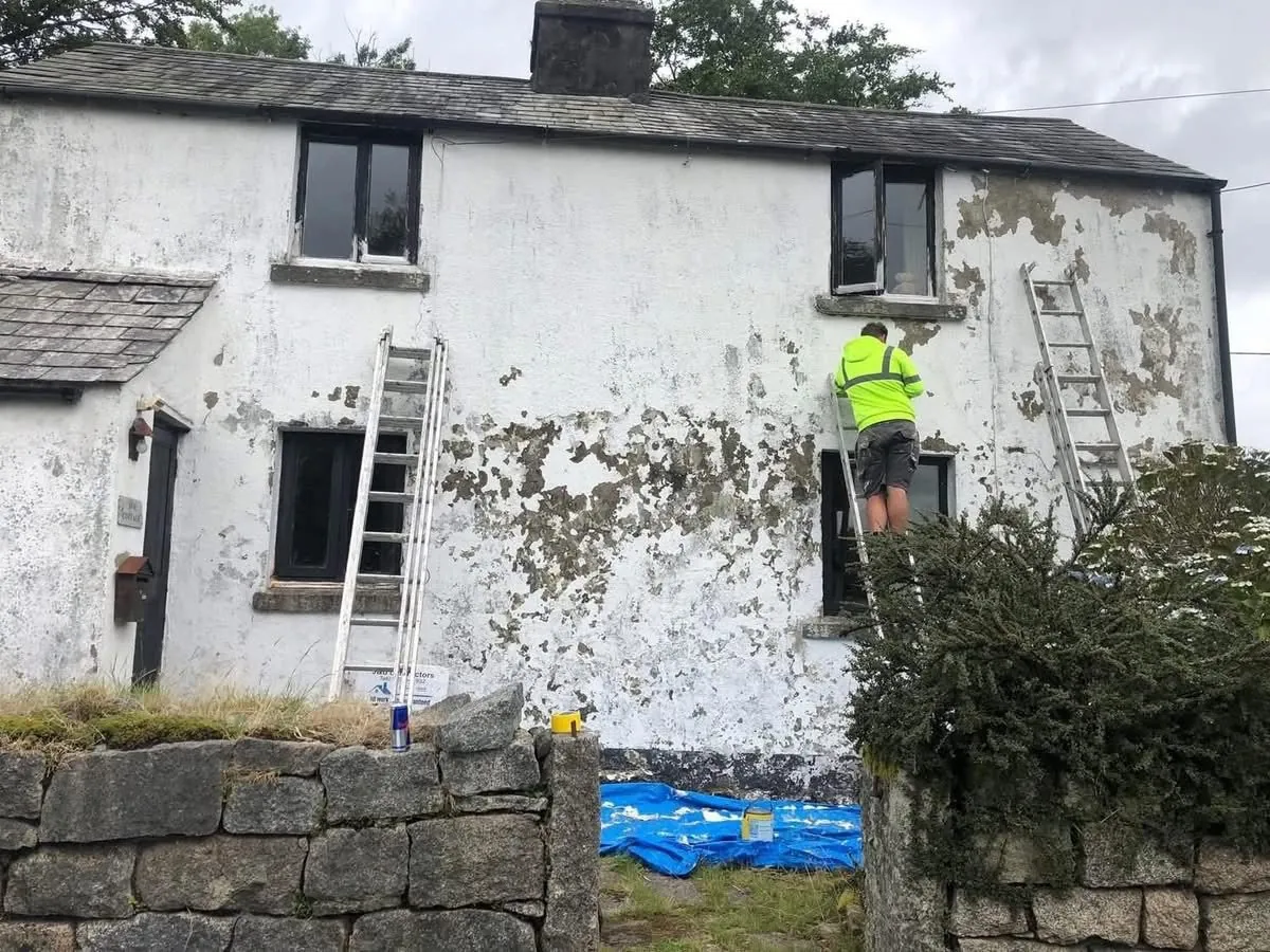 Cottage with blown, flaking render before repair in Bovey Tracey